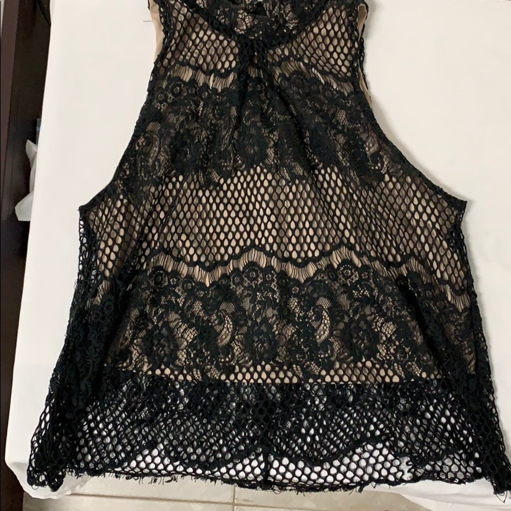 Beautiful black top with nude blouse on the inside